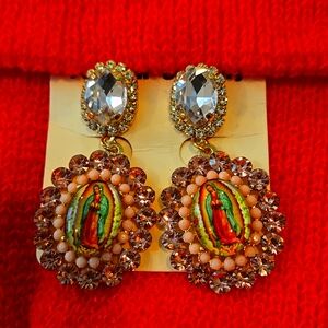 Dangle bejeweled earrings . Our blessed Mother conversation pieces